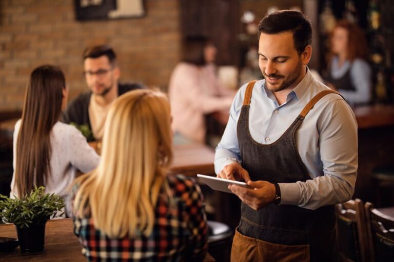 Garçom anotando pedido no tablet em um restaurante