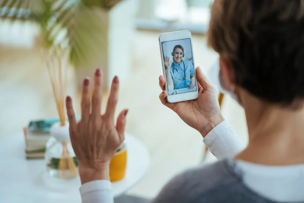 Paciente conversando com a médica pelo celular em atendimento digital